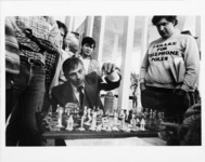 <span itemprop="name">A picture of students watching a chess match in a...</span>