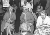 <span itemprop="name">Three unidentified women seated at an event...</span>