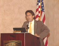 <span itemprop="name">An unidentified person addresses the audience at...</span>