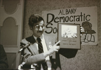 <span itemprop="name">John M. "Tim" Reilly holding a plaque during an...</span>