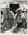 <span itemprop="name">An old man and young girl at a market stall. The...</span>