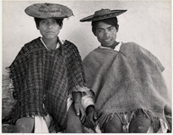 <span itemprop="name">Two boys in shawls and hats sitting next to a...</span>