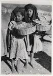<span itemprop="name">Two young girls with wraps on their heads holding...</span>