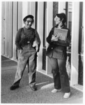 <span itemprop="name">Two unidentified students standing outside of the...</span>