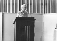 <span itemprop="name">An unidentified woman making a speech at the 50th...</span>