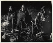 <span itemprop="name">Three women wrapped in shawls sitting on the...</span>