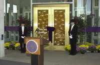 <span itemprop="name">Two unidentified persons stand near a doorway full...</span>