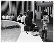<span itemprop="name">Unidentified students sitting around the fountain...</span>