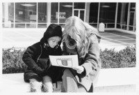 <span itemprop="name">An unidentified woman and young boy looking at a...</span>