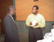 <span itemprop="name">Two unidentified persons converse at a reception...</span>