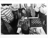<span itemprop="name">A picture of students watching a chess match in a...</span>