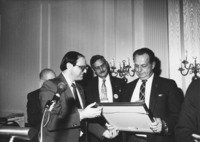 <span itemprop="name">Tom Corgliano presenting a framed award to an...</span>