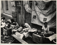 <span itemprop="name">Women selling food against the side of a building....</span>