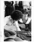 <span itemprop="name">A picture of two students, playing guitars and...</span>