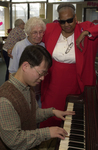 <span itemprop="name">An unidentified person plays piano for two seniors...</span>