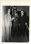 <span itemprop="name">Page 114 B-Bottom: Campus Day 1948: John Jennings, '49 (center) the first African-American student elected president of the Student Association (1948-1949) presents Donald Ely, '51, leader of the victorious Green Gremlins with the Campus Day Cup as Harold "Sparky" Vaugh, '50, leader of the Yellow Jackets, looks on.</span>