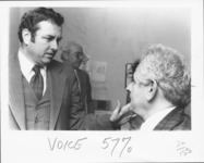 <span itemprop="name">Sam Wakshull (left) speaking with an unidentified...</span>