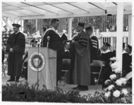 <span itemprop="name">An unidentified student receiving a diploma from...</span>