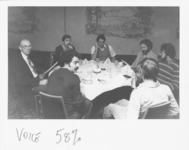 <span itemprop="name">Unidentified men seated at a table attending an...</span>