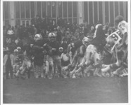 <span itemprop="name">A football game in play between the State...</span>