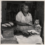 <span itemprop="name">A woman food-vendor selling tortillas with a baby...</span>
