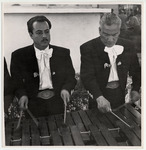<span itemprop="name">Two male Mariachi musicians playing a wooden...</span>