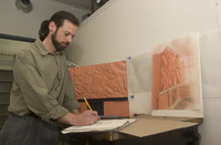 <span itemprop="name">M.F.A. student Chris Cassidy working on a piece of...</span>