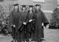 <span itemprop="name">Four female students wearing commencement gowns in...</span>