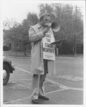 <span itemprop="name">An unidentified man speaking into a bullhorn...</span>