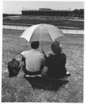 <span itemprop="name">An unidentified couple beneath an umbrella...</span>