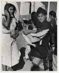 <span itemprop="name">A young woman in a black wrap, holding a basket...</span>