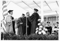 <span itemprop="name">An unidentified man receiving a doctoral degree...</span>