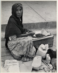 <span itemprop="name">An old woman street-vendor sitting on the street....</span>