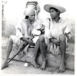 <span itemprop="name">Two young men in tunics and hats sitting on a...</span>