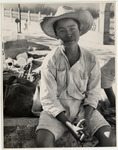 <span itemprop="name">A young man with a hat sitting....</span>