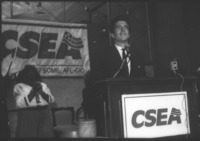 <span itemprop="name">John F. Kennedy Jr. addressing the delegates at...</span>