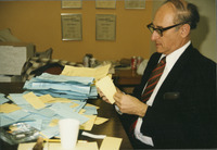 <span itemprop="name">Bruce Solnick surrounded by stacks of papers,...</span>