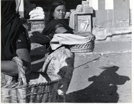 <span itemprop="name">Woman holding basket at her waist, as the wind...</span>