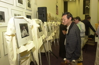 <span itemprop="name">An unidentified person reviews portraits at an...</span>