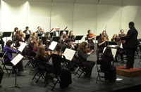 <span itemprop="name">Musicians watch their conductor for cues during...</span>