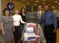 <span itemprop="name">Unidentified persons pose near a TV at the opening...</span>