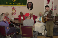 <span itemprop="name">An unidentified person plays guitar for a group of...</span>