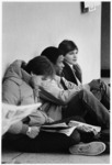 <span itemprop="name">Three unidentified students sitting on the floor...</span>