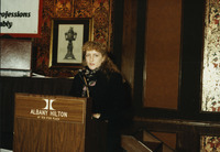 <span itemprop="name">An unidentified woman speaking from a podium...</span>
