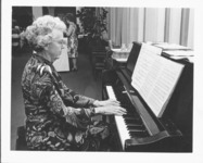 <span itemprop="name">An unidentified woman playing the piano during the...</span>