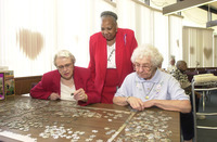 <span itemprop="name">Three unidentified persons work on a jigsaw puzzle...</span>