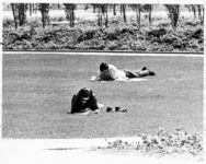 <span itemprop="name">Two unidentified students lounging on the lawn and...</span>