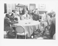 <span itemprop="name">Unidentified people seated at a table while...</span>