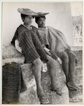<span itemprop="name">Two young men in flat straw hats sitting on...</span>