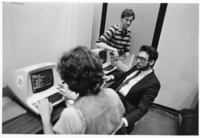 <span itemprop="name">An unidentified student uses a computer while two...</span>